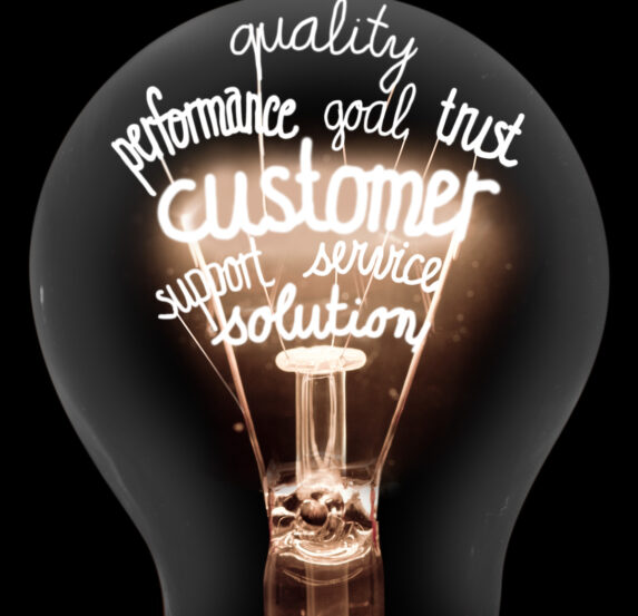 Photo of light bulbs group with shining fibers in a shape of Customer, Support, Feedback and Reliability concept related words isolated on black background